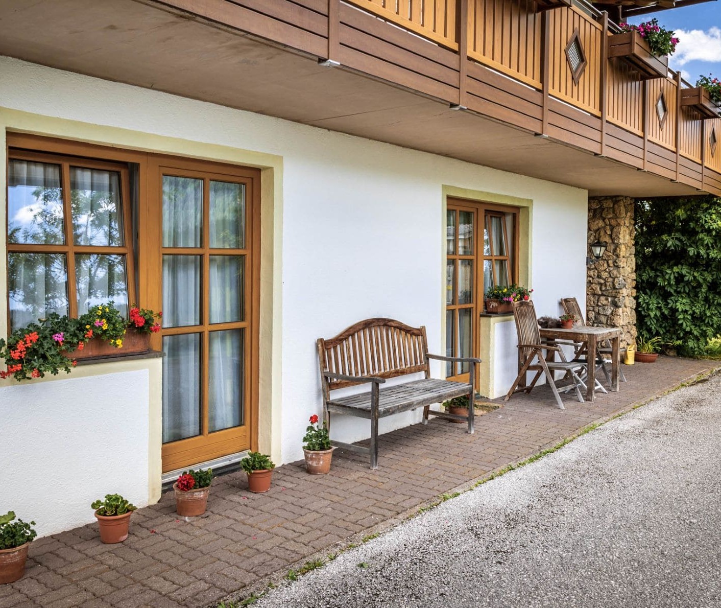 Hausmauer mit gemütlichen Sitzgelegenheiten und Blumen © Bernd Suppan